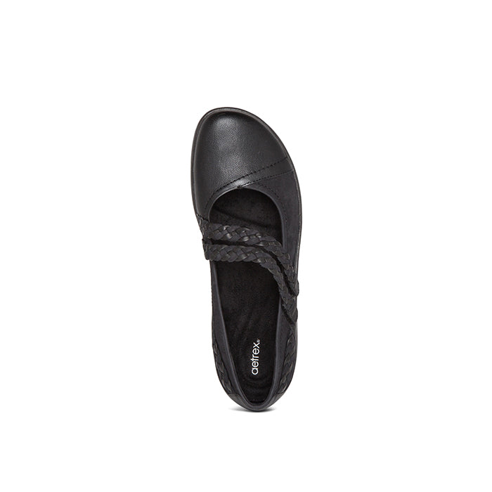 Top view of the Aetrex Womens Annie Mary Jane Black by AETREX WORLDWide INC, featuring a rounded toe, two crisscross braided straps, an orthotic footbed with "Aetrex" on the insole, set against a plain white background.