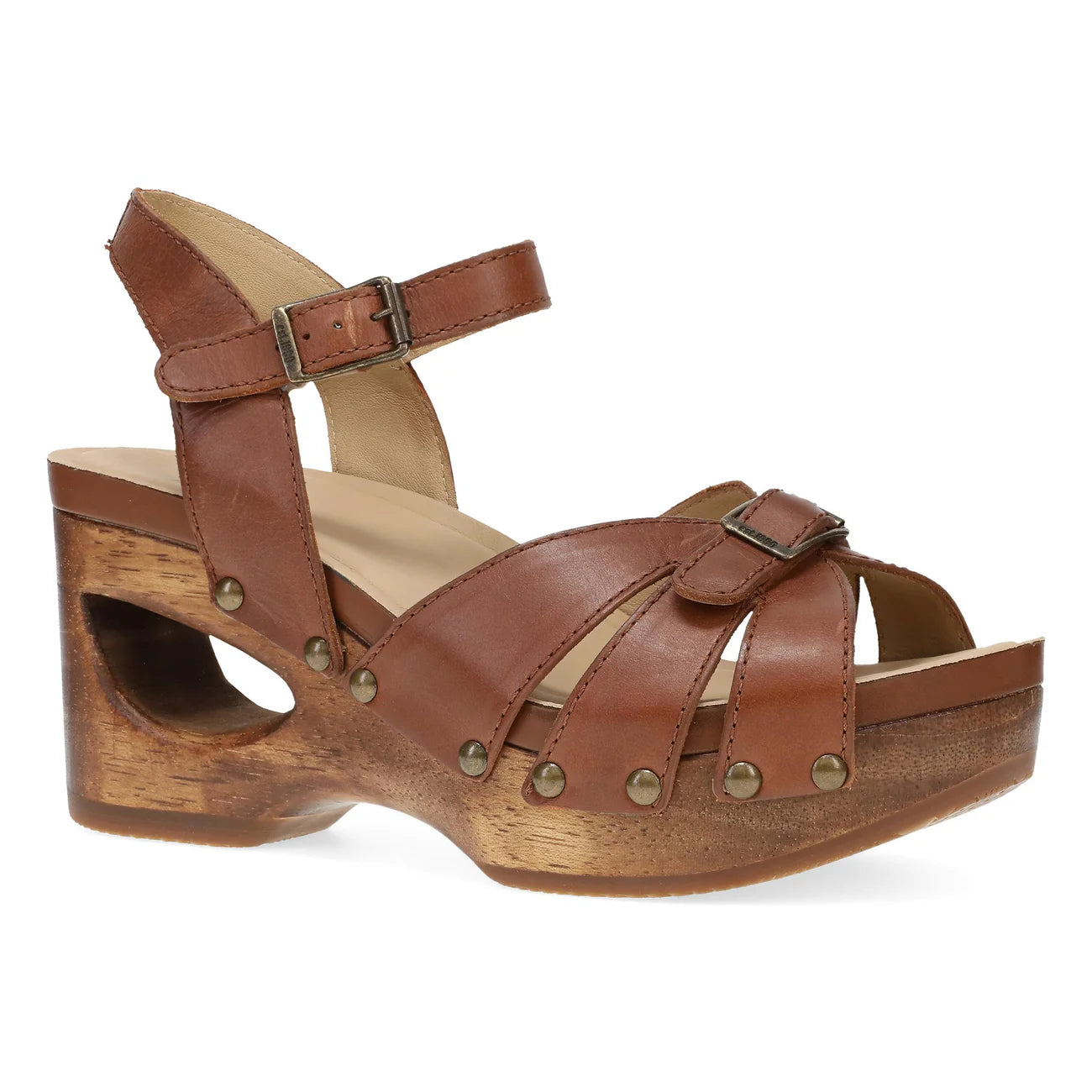 The Dansko Womens Alanna Tan sandal by DANSKO features an adjustable ankle strap, gold studs, and a chunky cutout wooden heel—combining stylish platform support with all-day comfort.