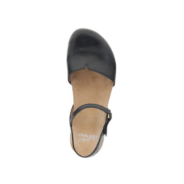 Top view of a Dansko Womens Rowan Black Waxy Mary Jane shoe by DANSKO, featuring black leather, a tan insole, ankle strap with buckle, and designed for foot pain relief, displayed on a white background.