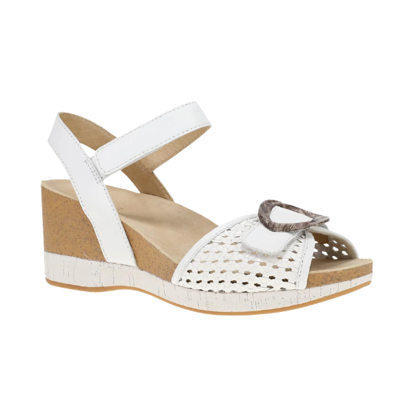 Dansko Women's Stella White wedge sandal with ankle strap, woven toe, buckle, and cork-textured sole by DANSKO.