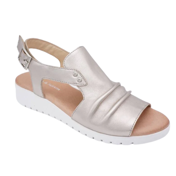 The Django & Juliette Womens Madis Plantino sandal features a silver metallic finish, ruched upper, adjustable ankle strap, cushioned insole, and white sole—ideal for all-day comfort and style.