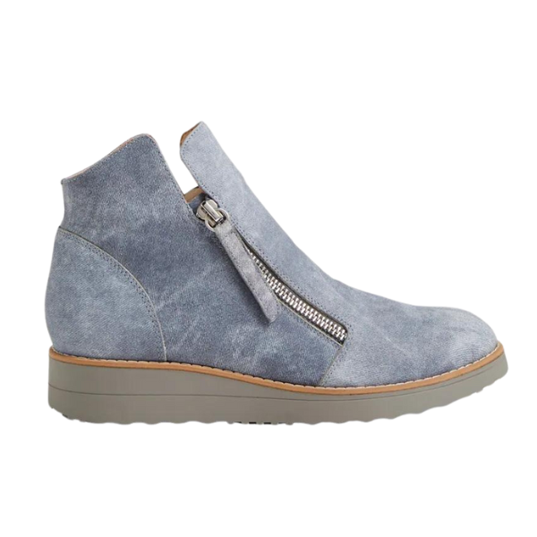 The Django & Juliette Womens Ohmy Denim bootie by DJANGO & JULIETT features gray suede, a side zipper, tan sole, and low wedge heel—shown from the side on a white background and designed to help minimize foot pain.