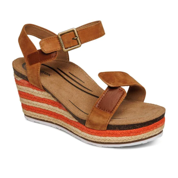 The Aetrex Womens Sydney Cognac by Aetrex features brown wedge sandals with ankle and toe straps, an adjustable espadrille strap with buckle, a striped brown-orange-beige layered sole, cushioned insole with arch support, and open toe design.