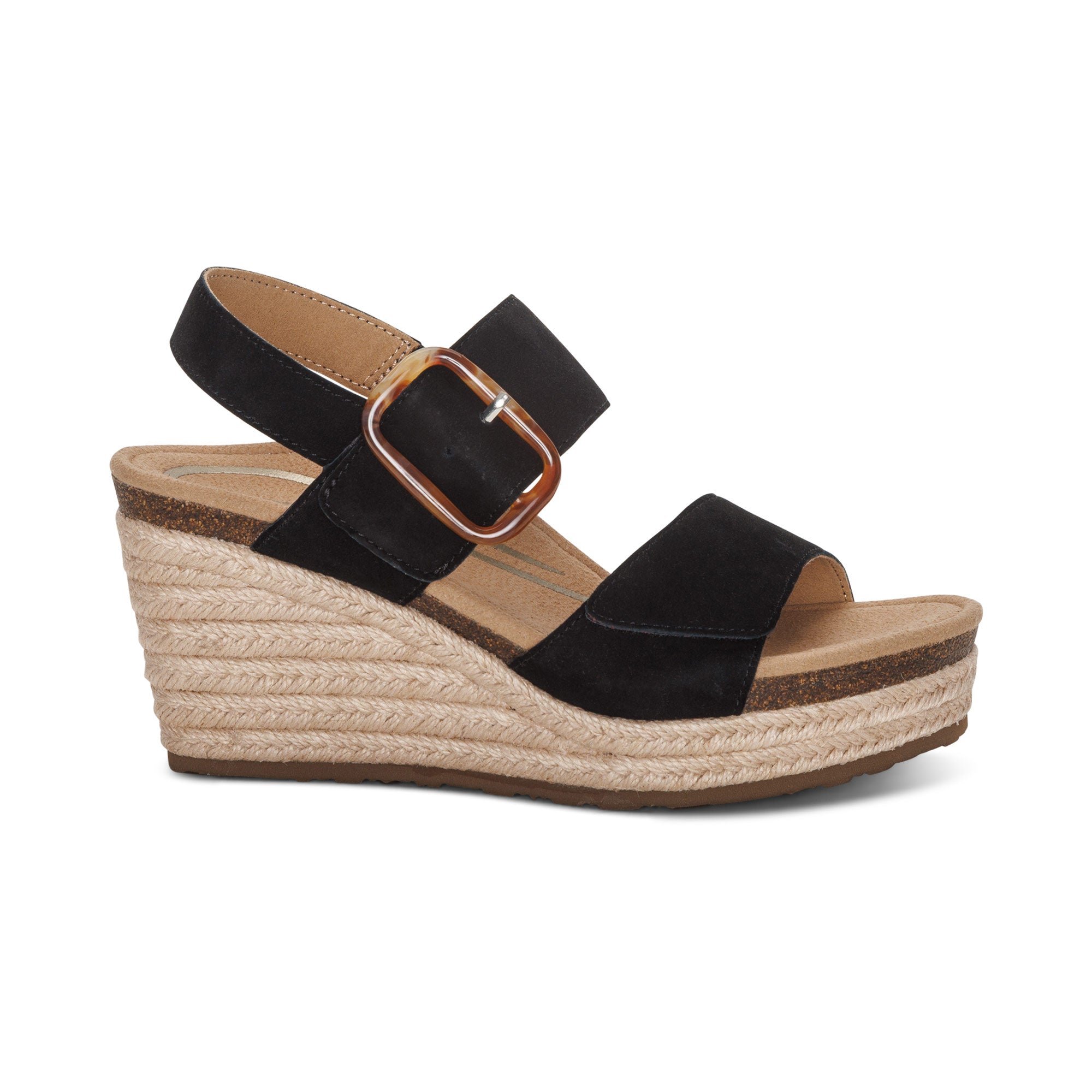 The Aetrex Women's Ashley Espadrille Wedge Black by AETREX WORLDWide INC features two wide straps (one with a bold buckle), a tan braided platform sole, and built-in arch support, making them stylish and comfortable—even for plantar fasciitis.