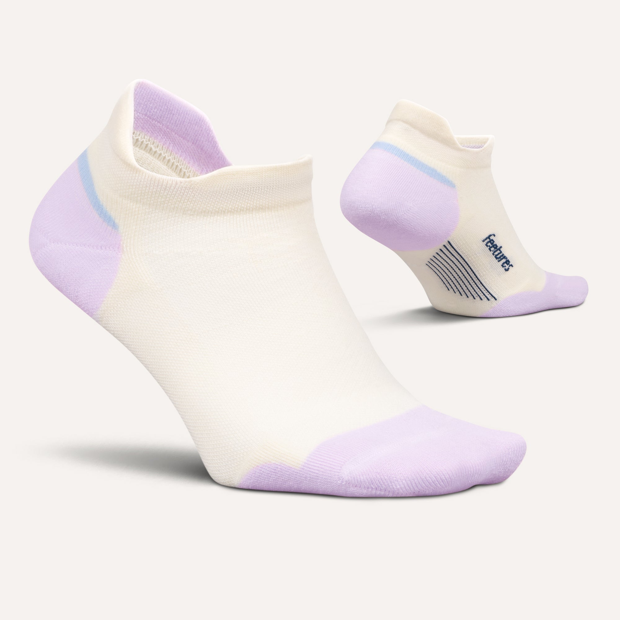 Pair of FEETURES Elite Max Cushion No Show Tab socks in Lilac Breeze, targeted arch compression, angled view.