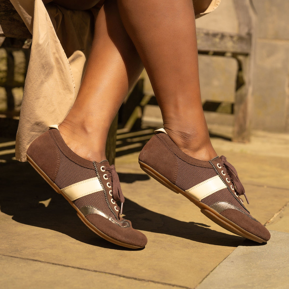DANSKO Women's Milana Chocolate/Pewter Suede flat worn in a lifestyle setting, sneakerina style.