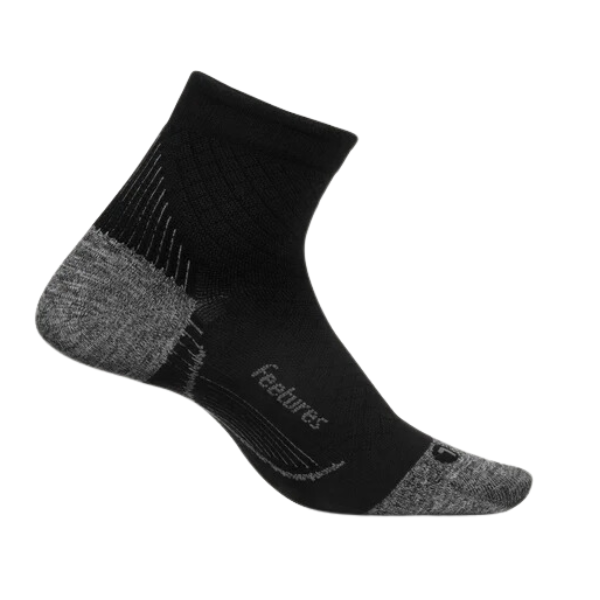 The FEETURES Unisex Plantar Fasciitis Relief Sock Ultra Light Quarter in White/Black offers targeted compression and support, with ribbed and mesh textures and feetures printed by the arch for relief and comfort.