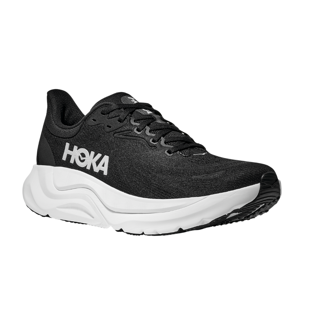 The HOKA Mens Arahi 8 Wide in Black/White is a stability shoe with an H-frame cushioned sole and bold white HOKA logo, displayed at an angle on a plain white background.