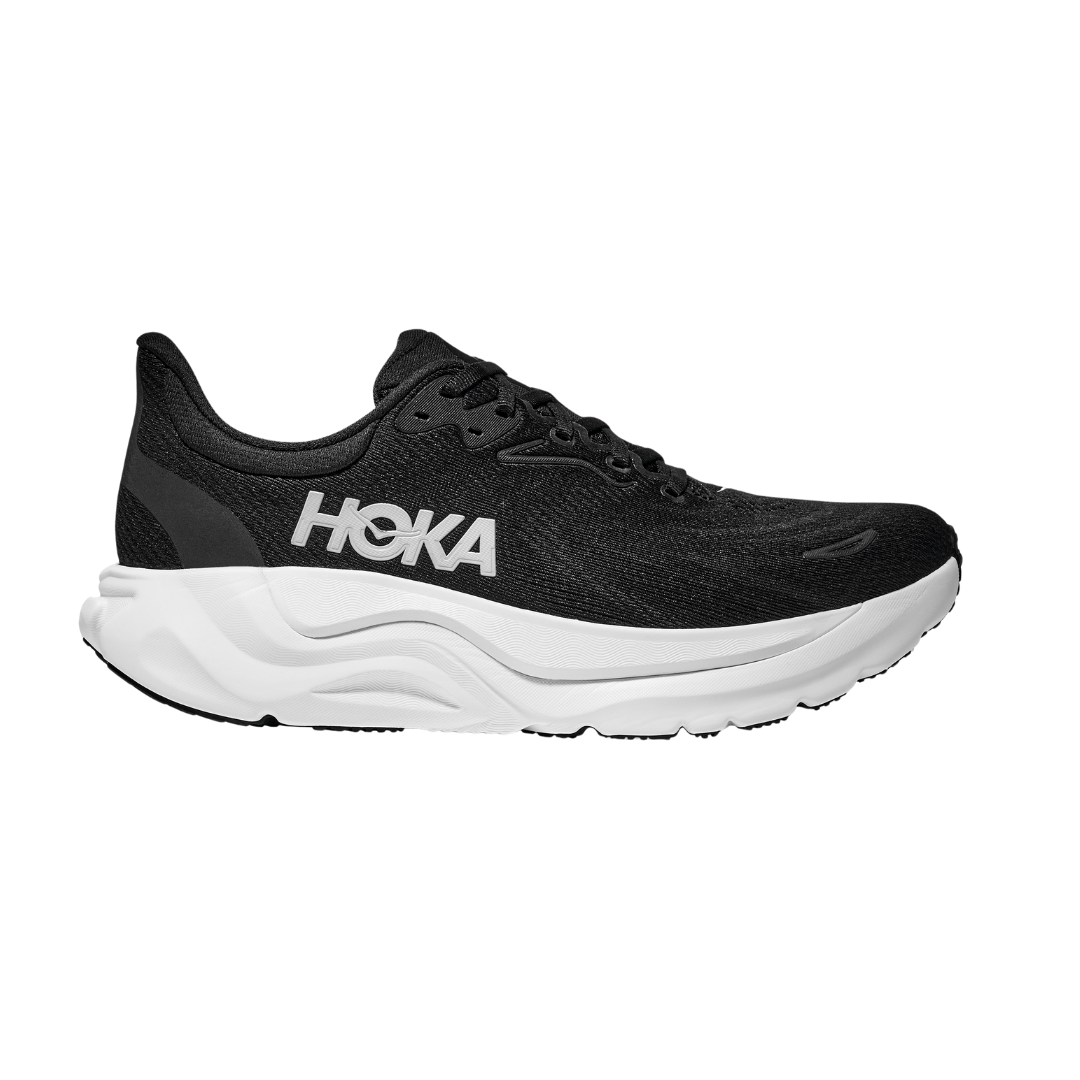 The HOKA Mens Arahi 8 Wide Black/White is a black stability shoe with a thick white sole, black laces, and a white HOKA logo on the side, shown in profile on a plain white background.