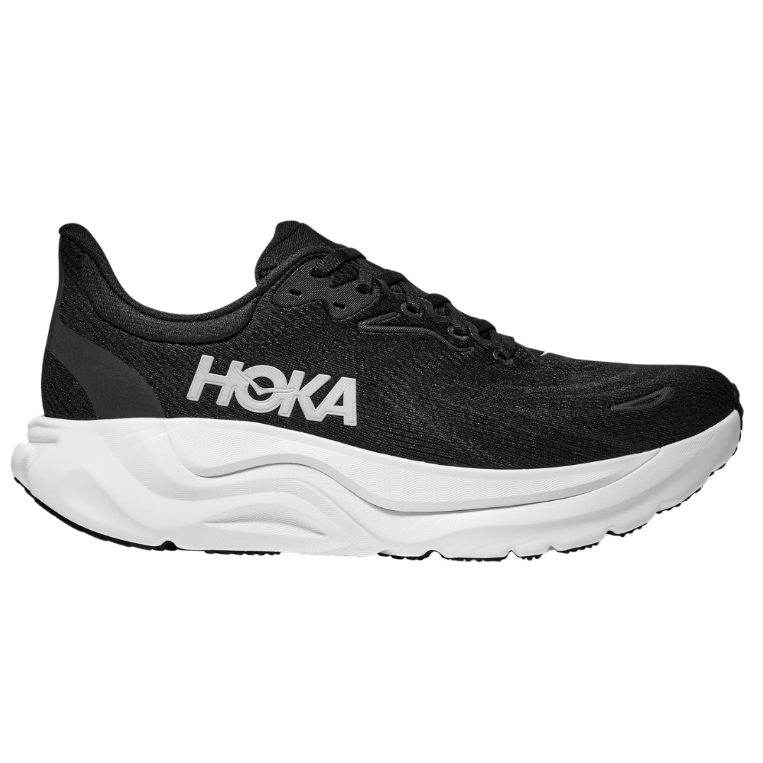 The HOKA Womens Arahi 8 Wide Black/White is a stability running shoe featuring a black upper, white logo, and thick textured white sole—engineered by HOKA for exceptional support and durable comfort.