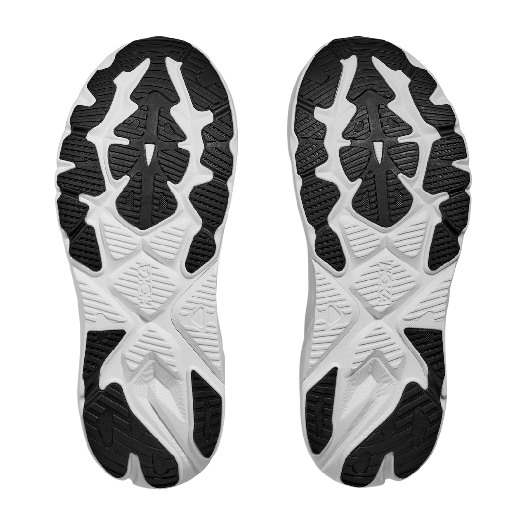 The HOKA Womens Arahi 8 Wide Black/White features mirrored black and white geometric tread patterns on the soles, offering reliable grip and support—perfect for those seeking a stability shoe from HOKA.