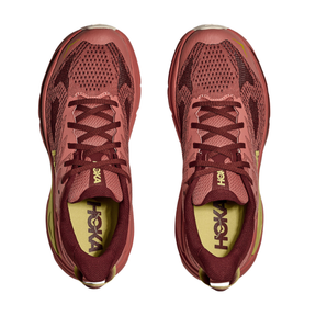 Pair of red running shoes with 'Hoka' branding on a white background