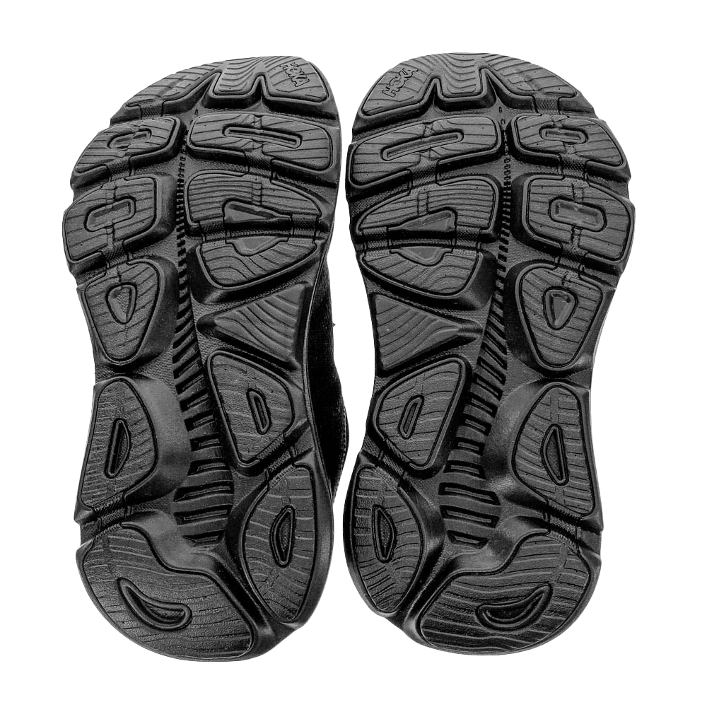 The image displays the soles of HOKA Womens Gaviota 5 Wide Black shoes, featuring black rubber with detailed tread patterns and grooves for excellent grip—ideal for those seeking relief from foot pain.