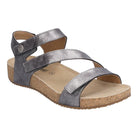 The Josef Seibel Womens Tonga Anthrazite sandal features a metallic silver finish, cork sole, beige footbed, three adjustable straps, and an ankle strap with circular detail for comfort and foot pain relief.