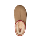 Top view of the UGG Women's Tasman II Sand slide by UGG, featuring a fuzzy cream interior and red patterned trim. This sheepskin slipper displays the signature UGG logo on its insole for a classic finish.