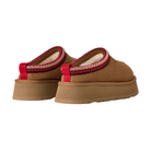 A pair of UGG Women's Tazz II Chestnut platform suede slippers with thick tan soles, sheepskin lining, red pull tabs at the back, and red-and-white stitching around the opening, shown from the rear.
