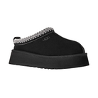 The UGG Women's Tazz II Black is a platform suede slipper with a thick sole, white stitching around the opening, plush sheepskin lining, and a small UGG logo on the side.