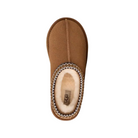 A top view of the UGG Women's Tasman II Chestnut slipper shows its fuzzy cream lining, patterned trim around the opening, and the UGG logo on the insole.