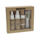 The BIRKENSTOCK Deluxe Care Kit features shoe cleaner, Water & Stain Repellent, Cork Sealer, and a brush, all packaged in a brown box with a clear window.