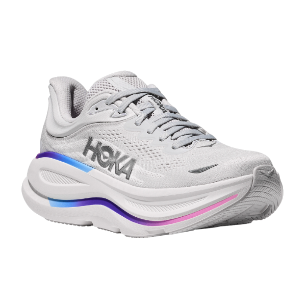 The HOKA Womens Wide Bondi 9 in Cosmic Grey/White features thick cushioning for comfort, a mesh upper, gradient blue and purple midsole accents, and the HOKA logo on the side.