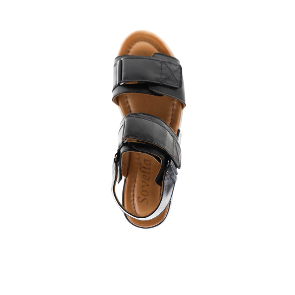 The Sovella Womens Maya Black sandal by SOVELLA features two Wide straps and a brown cushioned insole for foot pain relief, with the brand embossed on top. The sandal is shown from above, isolated on a white background.