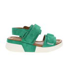 The Sovella Womens Maya Green by SOVELLA is a green suede platform sandal with thick adjustable straps, a cushioned tan insole, and a chunky white sole, shown from the side on a white background.