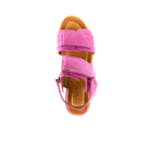 The Sovella Womens Maya Pink sandal by SOVELLA features two pink straps and a tan cushioned insole with the brand name visible, shown from above on a white background.