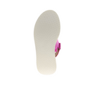 The image displays the bottom of the Sovella Womens Maya Pink sandal by SOVELLA, featuring a textured white sole, cushioned insole, and a visible pink strap against a plain white background.