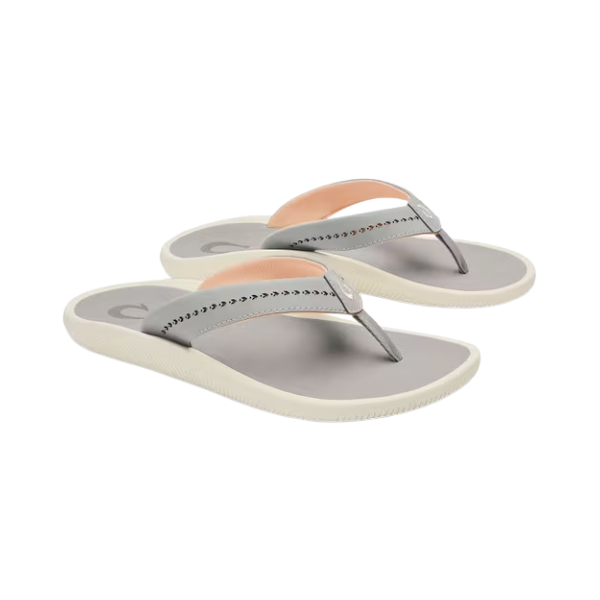 Pair of gray flip-flops with pink straps on a white background