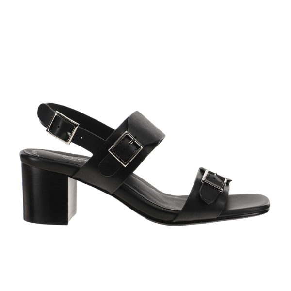 The Sovella Womens Celeste Sandal Black by SOVELLA is a black leather sandal with a mid-height block heel, cushioned footbed, open toe, and two large square adjustable buckle straps on front and ankle.