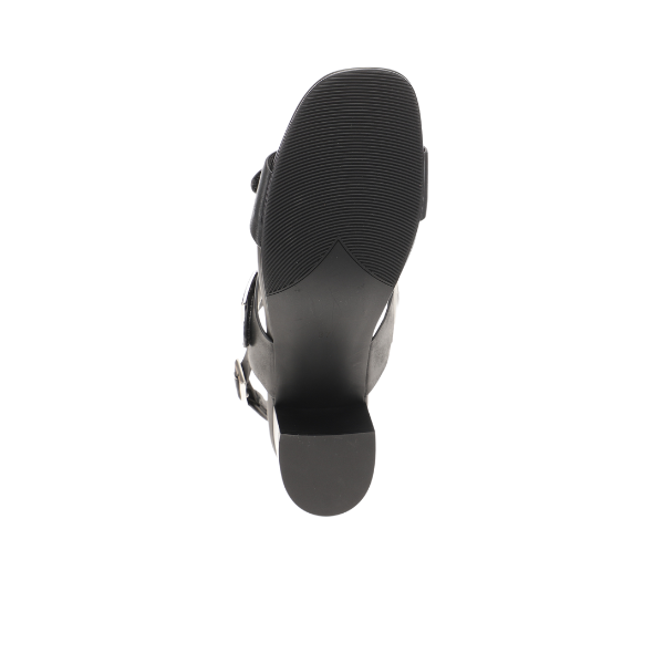 The SOVELLA Sovella Womens Celeste Sandal Black is shown from the bottom, highlighting its textured rubber sole, low heel, cushioned footbed, and adjustable buckle straps against a white background.