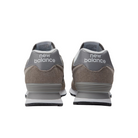 The New Balance Mens 574 Core Neutral shoes in gray feature suede and mesh uppers with white New Balance branding on the heels—versatile footwear for everyday style.