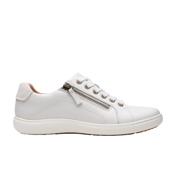 The Clarks Womens Nalle Lace White by CLARKS is a white low-top zip-up sneaker with white laces, silver eyelets, and a white rubber sole. It features a Contour Cushion footbed for foot pain relief. Shown in side profile on a white background.