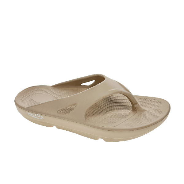 The Sovella Womens PF Thong Beige sandal features a thick sole, Wide thong strap, textured footbed, and open-toe design. Enhanced arch support and the SOVELLA name on the side combine style with comfort.