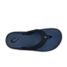 A single OLUKAI Mens Ohana sandal in Deep Blue/White, featuring a fishhook-shaped logo on the heel and strap, thick straps, and a dark blue footbed—water-resistant and shown from above on a white background.