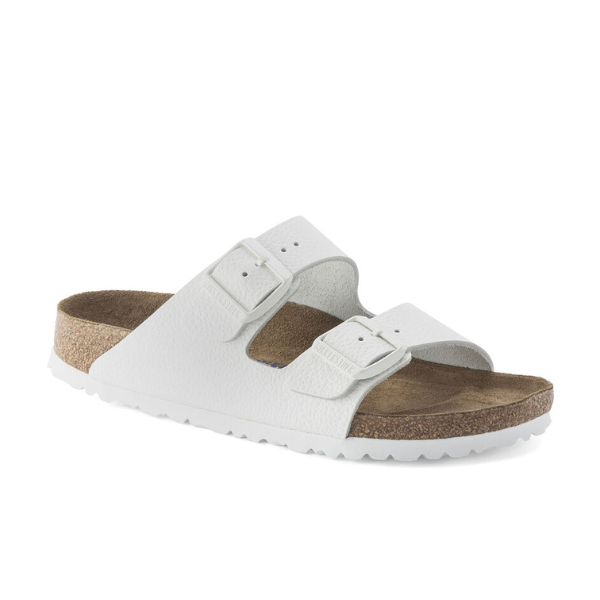 The Birkenstock Womens Arizona Soft Footbed White sandal by BIRKENSTOCK features two adjustable buckle straps, a soft cork footbed for comfort, and a textured sole for grip.