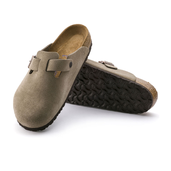 A pair of BIRKENSTOCK Womens Boston Soft Footbed clogs in taupe, featuring buckles, cork midsoles, and black textured rubber soles, shown against a white background.