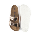 A pair of BIRKENSTOCK Womens Arizona Soft Footbed Leather Sandals in White Copper; one sandal is shown from the top, highlighting two buckled straps, while the other displays the textured white sole.