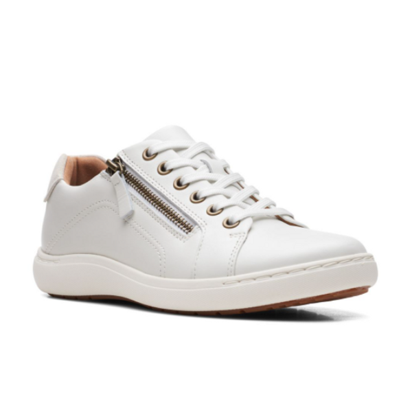 The Clarks Womens Nalle Lace White is a white leather zip-up sneaker by CLARKS with white laces, silver eyelets, side zipper, light brown lining, and white sole. It features a Contour Cushion footbed for relief and is shown on a plain white background.