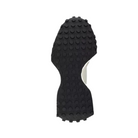 The black rubber sole of the NEW BALANCE Womens 327 White/Black sneaker features a textured surface with circular grip patterns, shown from the bottom and isolated on a white background.