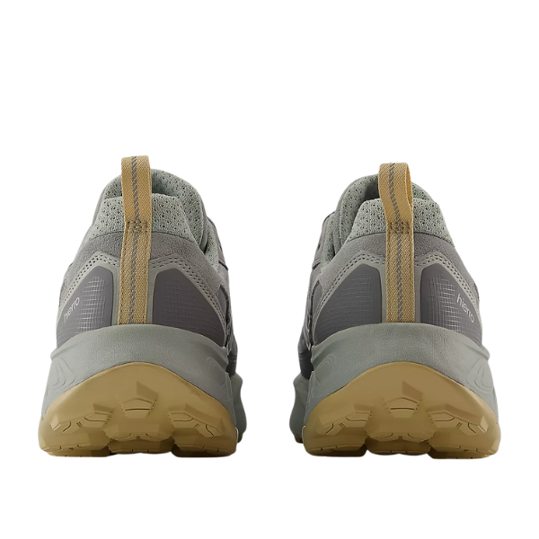 Pair of gray hiking shoes with tan soles on a white background