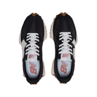 The New Balance Womens 327 Black/White running shoes feature white laces, red New Balance logo insoles, and gum brown soles, shown here from above.