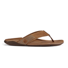 The OLUKAI Mens Tuahine Toffee flip-flop features a textured, Hawaiian-inspired strap, open toe design, cushioned footbed, and slightly raised sole in brown, shown from the side against a white background.