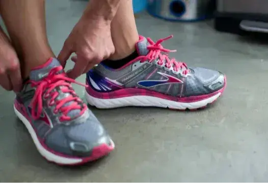 man putting on running shoes