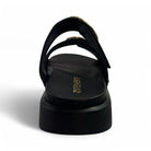 A back view of the Revere Womens Mermaid Black sandal by REVERE, featuring two straps, a slight heel, and the gold revere logo on the footbed.