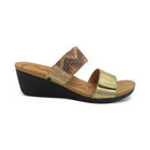 The REVERE Revere Womens Sorrento Gold features a black sole, tan footbed, gold textured strap, and multicolored zigzag strap—delivering chic support perfect for those seeking stylish orthotic wedge shoes to help relieve foot pain.
