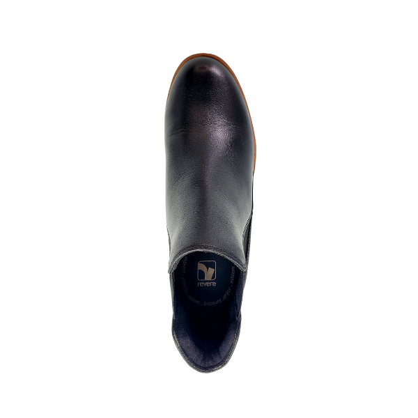 A top view of the REVERE Womens Galway Wedge Bootie Wide in black, highlighting its brown sole, visible brand logo inside the heel, and premium leather upper for lasting style.