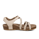 The Aetrex Womens Jillian Ivory sandal by Aetrex features a cork sole, braided straps, closed heel, and an orthotic footbed for all-day comfort. Displayed on a white background in an elegant beige shade.