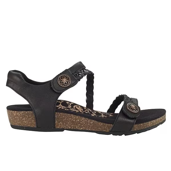 Aetrex Womens Jillian Black sandal features a low cork wedge, adjustable straps with round buckles, braided upper detail, and a patterned insole with an orthotic footbed for enhanced comfort.