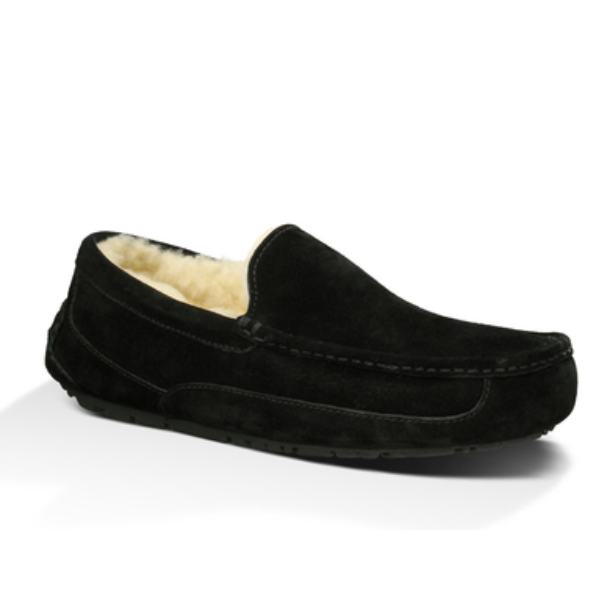 The UGG Mens Ascot Slipper Black is a suede loafer-style slipper with visible stitching and a plush cream lining, designed by UGG for foot pain comfort and shown at an angle on a white background.